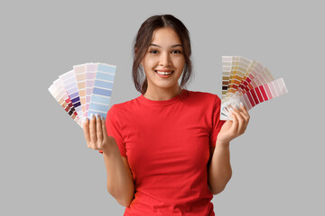 Wall Mural - beautiful young woman with different palette samples on grey background