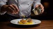 © ahmed elmaslamani - Chef preparing scallops dish with yellow sauce and truffle garnishing