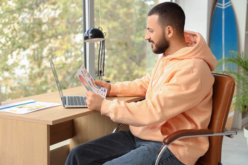 Fototapete - Graphic designer working with laptop and color palette at home