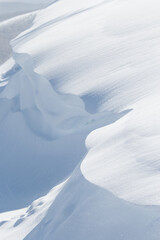 Wall Mural - curved edge of large white snowdrift in winter landscape