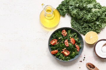 Wall Mural - Composition with bowl of tasty kale salad, spices and oil on light background