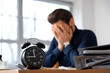 © Pixel-Shot - Stressed businessman missing deadlines in office