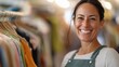 © Design@22 - A smiling woman stands in a clothing store, showcasing a positive atmosphere and customer engagement.