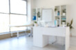 © Pixel-Shot - Blurred view of medical office with doctor's workplace and shelf units