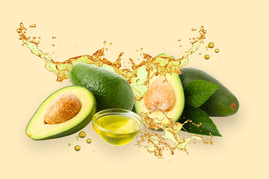 Healthy food, Avocados, leaves and oil on beige background