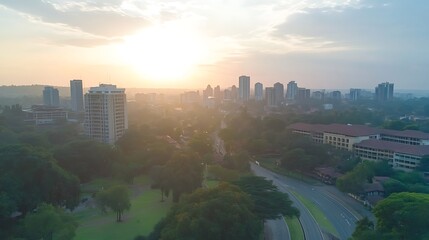 Poster - Aerial view of a vibrant city skyline at sunset with green parks and roads.