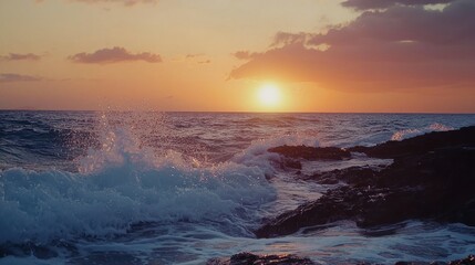 Aufkleber - Waves gently crashing against volcanic rocks as the Hawaiian sunset paints the sky in orange and pink.