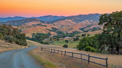 Poster - A serene countryside with rolling hills glowing under the warm orange light of sunset.