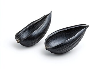 Poster - Two polished black seed pods with polished surface texture on white background showcasing natural design : Generative AI