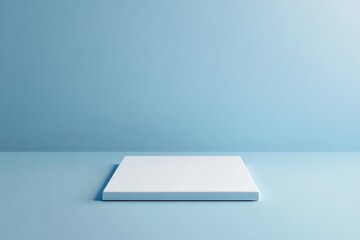 Fototapete - A plain white pedestal sits on a blue colored platform