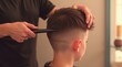 © vitanovski - Professional Barber Creating a Stylish Haircut for a Young Boy