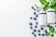 © RYUJIN Studio - Clean white backdrop with probiotic bottles and yogurt, scattered blueberries and digestive enzymes, minimalist arrangement with center text space