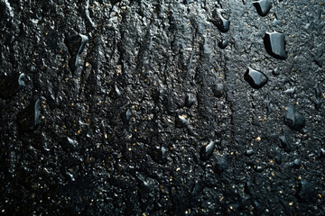 Poster - Dark, textured surface with water droplets, creating a dramatic, wet aesthetic.