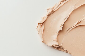 Poster - Creamy beige cosmetic application on a smooth surface in a well-lit space showcasing texture and color nuances