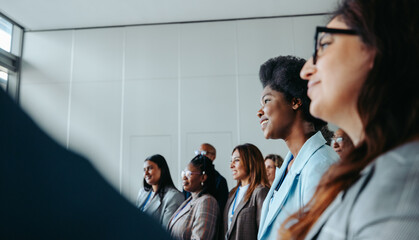 Wall Mural - engaged group of business professionals attending a conference in modern office setting