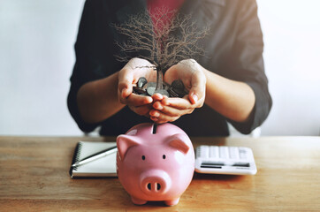 Poster - woman is holding a piggy bank full of coins