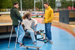 © zinkevych - Group of skateboarders sitting on the bench in the park and talking