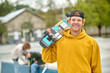 © zinkevych - Smiling ginger young guy with skateboard looking contented