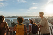 © bernardbodo - Tourists admiring lisbon skyline with 25th of april bridge at sunset from famous viewpoint