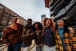 © bernardbodo - Group of happy multiracial friends walking and laughing together in Bilbao
