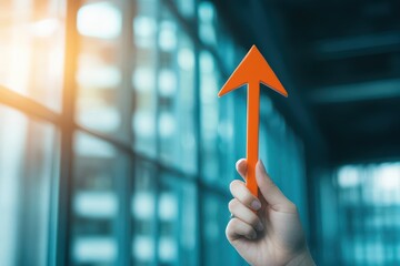 Poster - A Vibrant Hand Grasping a Bright Orange Arrow Against a Neutral Background Symbolizing Direction Motivation and Positive Energy in Daily Life Choices