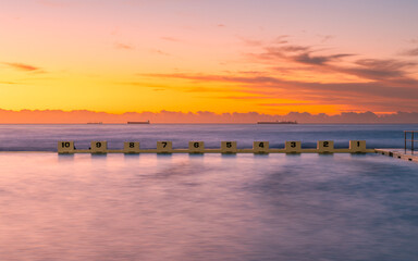 Wall Mural - Swimming lane block at Merewether Ocean Baths at sunrise time.