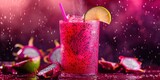 Floating dragon fruit juice with dragon fruit pieces and a lime wedge on a moody burgundy background
