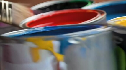 Poster - Multiple paintbrushes are dipping into various paint cans filled with vibrant colors, creating a dynamic and artistic scene, suitable for home improvement, diy, or art related projects