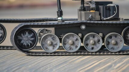 Fototapete - Autonomous tracked robot traversing concrete surface, demonstrating advanced mobility and precise navigation through rugged technological terrain