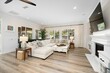 © Wirestock - Elegant open-concept living space with a cozy sofa, and stylish furnishings in a luxury home