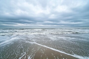 Poster - Lonely seashore with gentle waves under an overcast sky perfect for reflection and serenity Generative AI