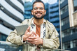 © Srdjan - Young hipster businessman with cool attitude standing out of office building working digital tablet. Expatriate business person standing out of the crowd, intelligent design professional occupation.