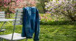 © Вася Пупкин - Spring denim jacket hanging on chair in a blooming garden