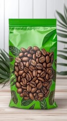 Poster - Close up of a green coffee bean bag, featuring roasted coffee beans and green leaves on a light wooden surface with tropical foliage in the background. The bag has a glossy finish. 