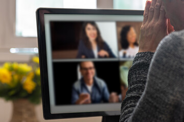 Poster - Man discussing work project with coworkers via webcam conference on computer. Home office setup with a man in a virtual conference, actively participating in an online conversation