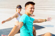 © muse studio - Group exercise session outdoors with smiling participants enjoying fitness routine in sunlight