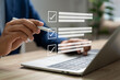 © GamePixel - Business performance monitoring and evaluation concept, Take an assessment, Business man using laptop and tablet online checklist survey, Filling out digital checklist, Questionnaire with checkboxes.