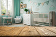 © Payel - A high-angle, close-up view of a light brown wooden tabletop, perfect for product placement or showcasing a baby-themed item.