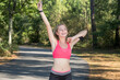 © auremar - young woman in sport outfit stratching before jogging in forest