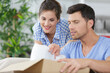 © auremar - couple unpacking boxes with property housewarming