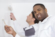 © auremar - two men painting wall in new apartment