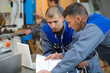 © auremar - industrial workers studying a plan