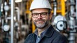 © Oleg - Industrial Engineer Portrait: Confident Man in Hard Hat Stands Amidst Complex Machinery