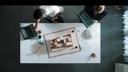 Poster - top down view of smart manager holding tablet and looking at laptop display building construction at