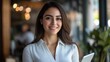 © Evon J - Hispanic young female professional smiling indoors holding tablet