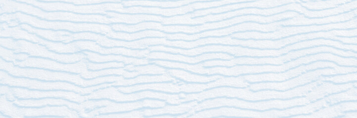 Wall Mural - wide panoramic winter background with snowy ground. natural snow texture. wind sculpted patterns on 