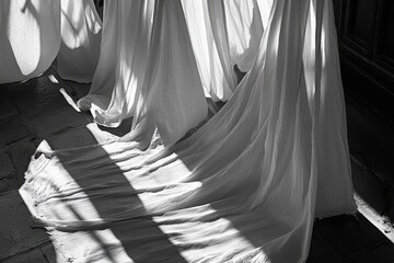Leinwandbilder - Soft white drapes cascade elegantly across stone floor with contrasting shadows from sunlight