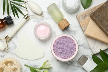 Wall Mural - flat lay composition with different body care products and flowers on white marble table