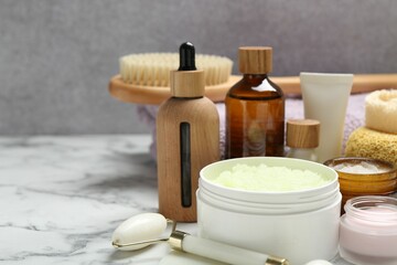 Wall Mural - different body care products on white marble table, closeup. space for text