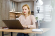 © Marko - Young woman working on laptop in modern office space
